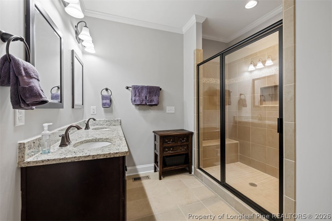 48 Valley Brook Lane Spring Lake, NC 28390 - Photo 20 of 50 a bathroom with a granite countertop sink a mirror a glass door and shower