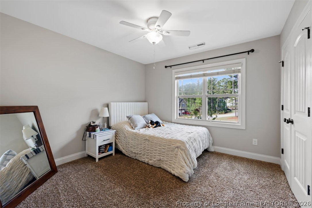 48 Valley Brook Lane Spring Lake, NC 28390 - Photo 24 of 50 a bed room with a bed and a chandelier