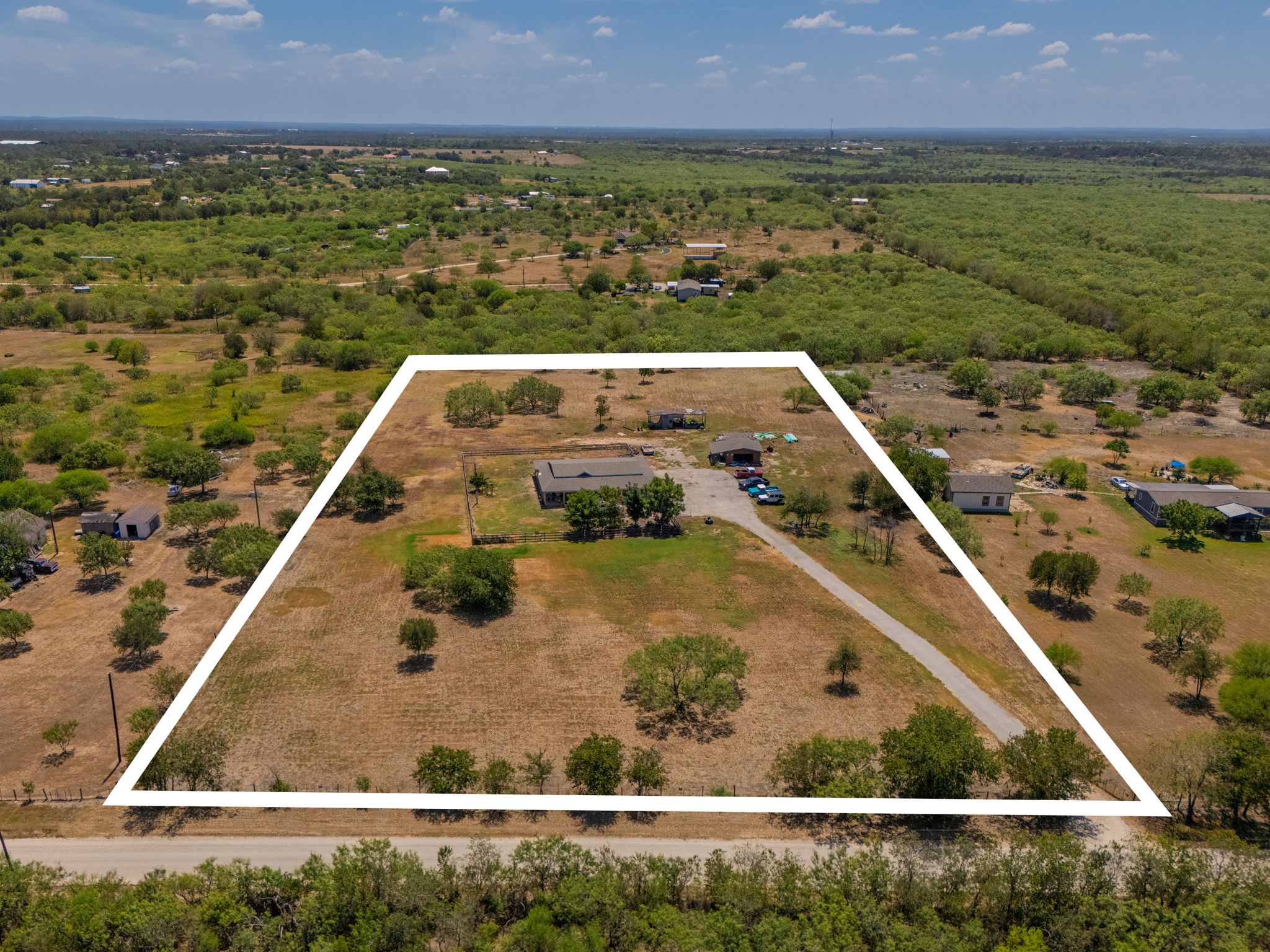 1781 Long Road Lockhart, TX 78644 - Photo 2 of 17 Sprawling acreage features a gated perimeter outline framing the residential structure and detached outbuildings.
