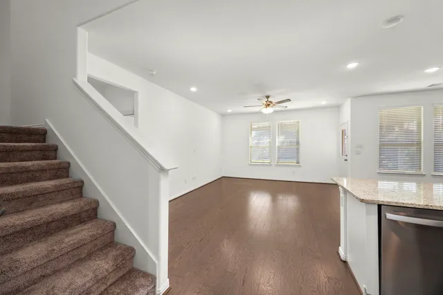 a kitchen with granite countertop sink stainless steel appliances and window