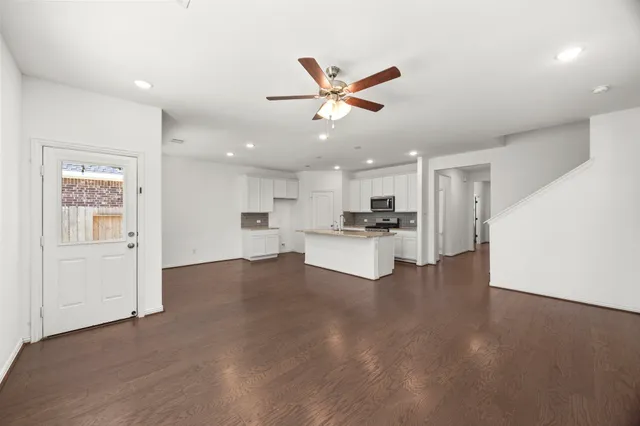 a view of kitchen with refrigerator sink and stove