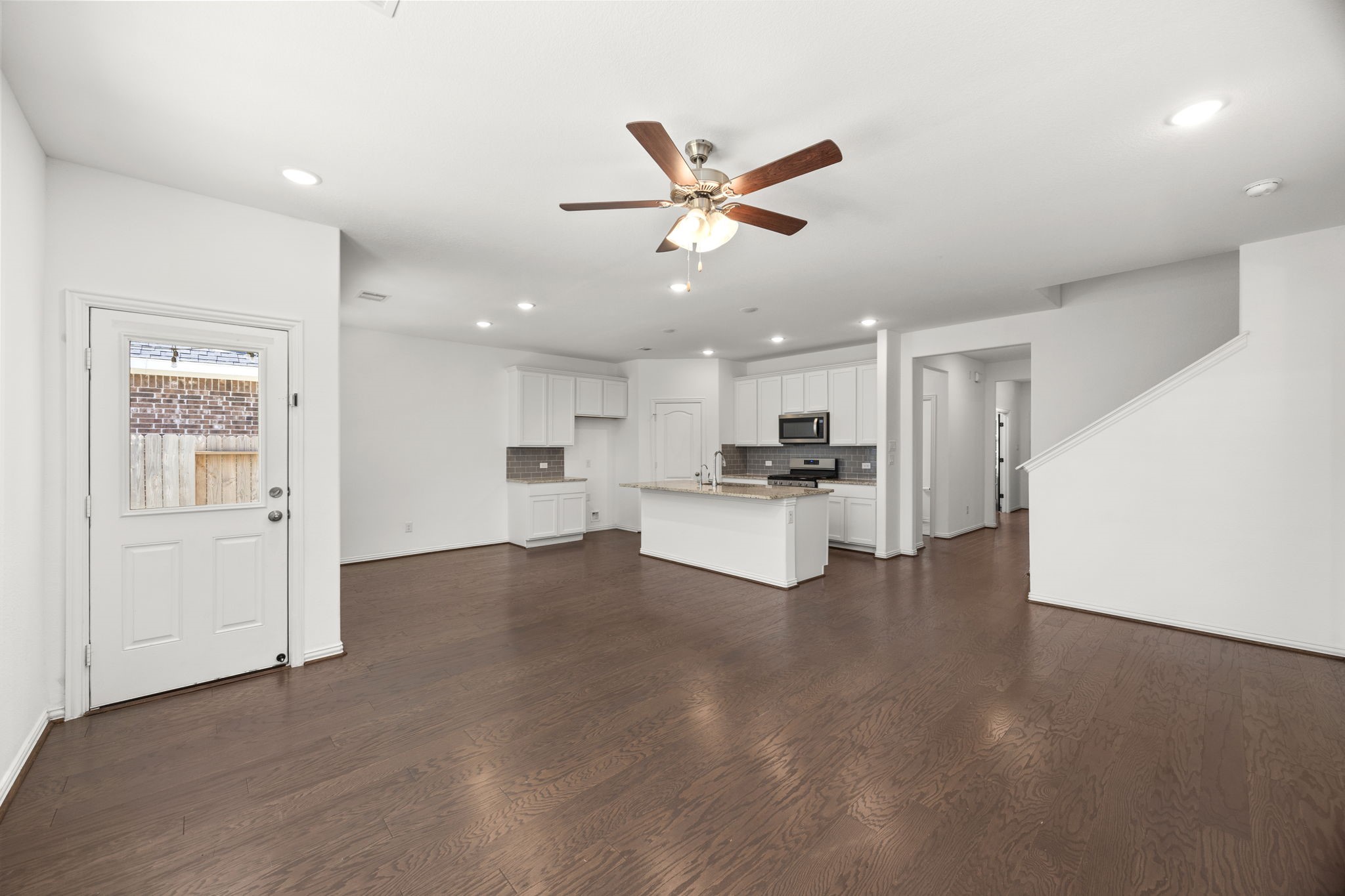 31319 Horseshoe Meadow Bend Lane Fulshear, TX 77441 - Photo 17 of 41 a view of kitchen with kitchen island stainless steel appliances refrigerator stove and white cabinets
