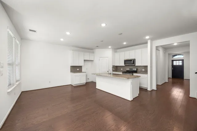 a view of kitchen with furniture and wooden floor