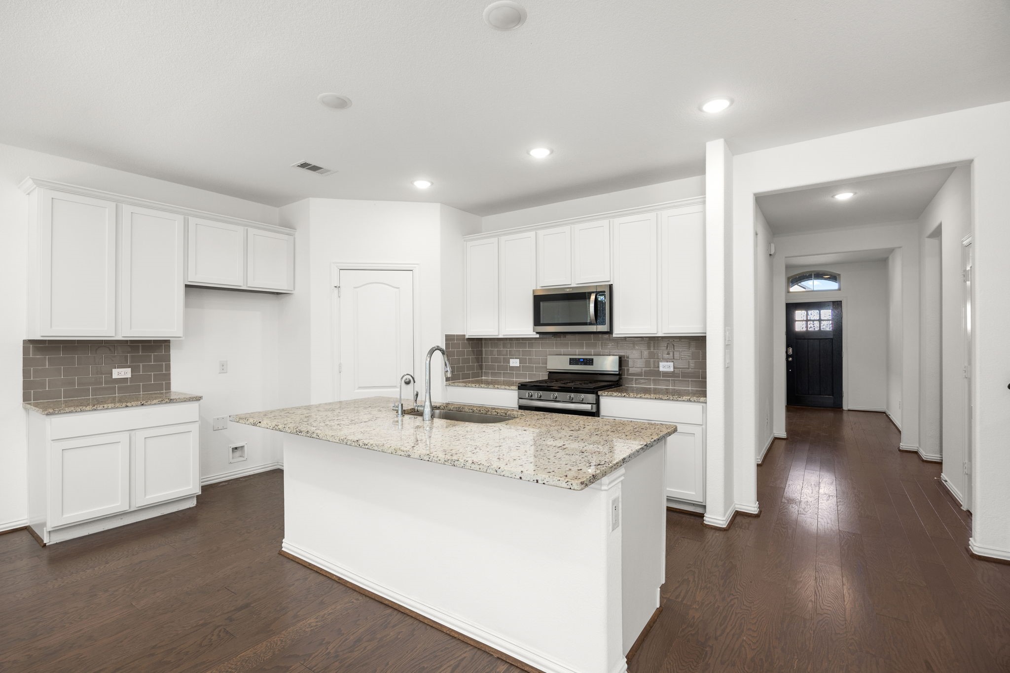31319 Horseshoe Meadow Bend Lane Fulshear, TX 77441 - Photo 20 of 41 a kitchen with granite countertop a sink a counter top space stainless steel appliances and cabinets