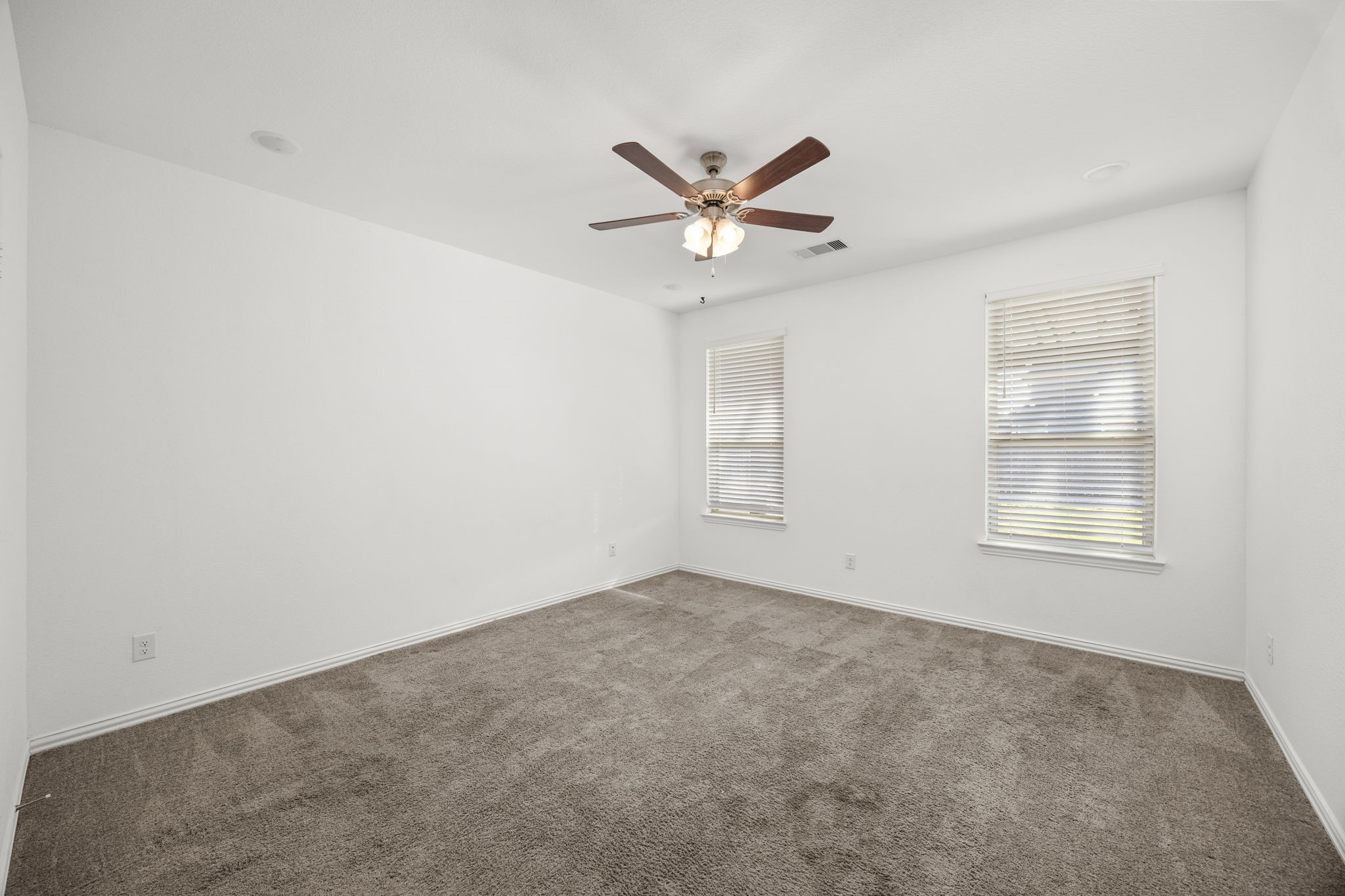 31319 Horseshoe Meadow Bend Lane Fulshear, TX 77441 - Photo 21 of 41 an empty room with a window and a fan