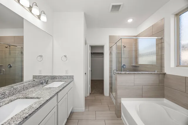 a bathroom with a bathtub and a sink