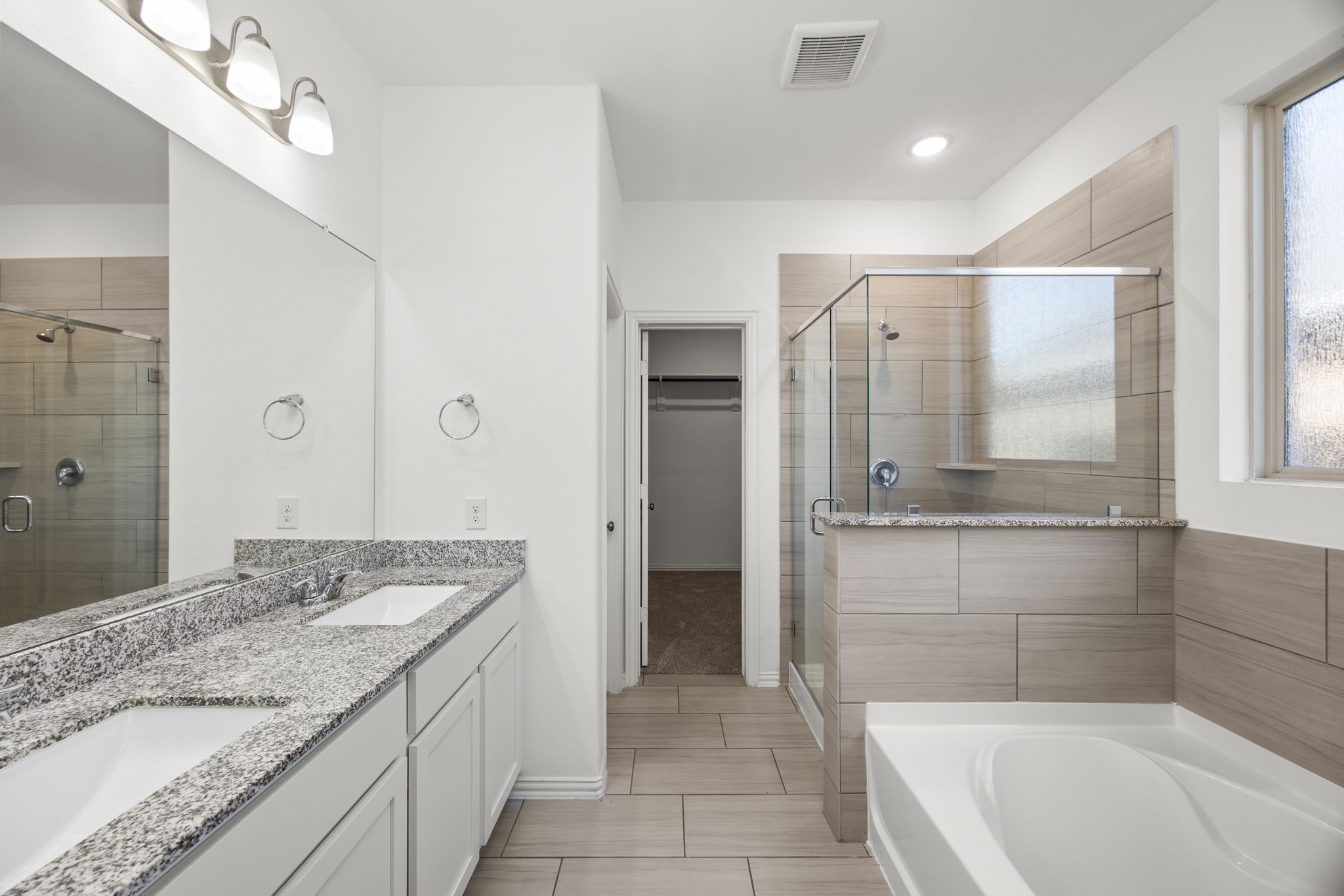 31319 Horseshoe Meadow Bend Lane Fulshear, TX 77441 - Photo 24 of 41 a bathroom with a granite countertop sink mirror and bathtub