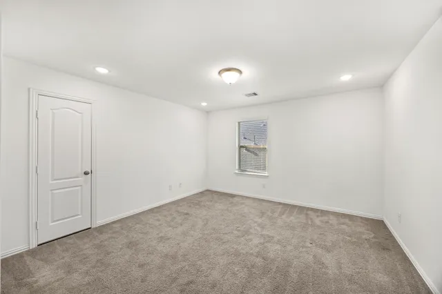 a room with furniture pool table and window