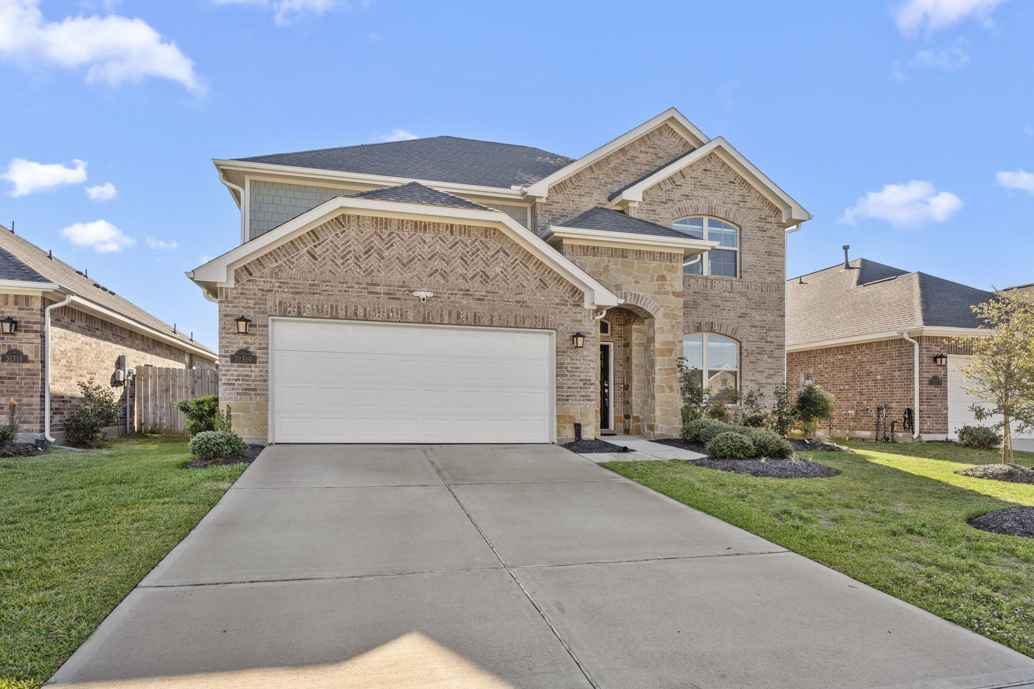 31319 Horseshoe Meadow Bend Lane Fulshear, TX 77441 - Photo 3 of 41 a front view of a house with a yard