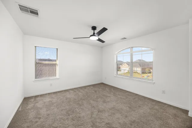 a bathroom with a granite countertop sink a toilet and shower