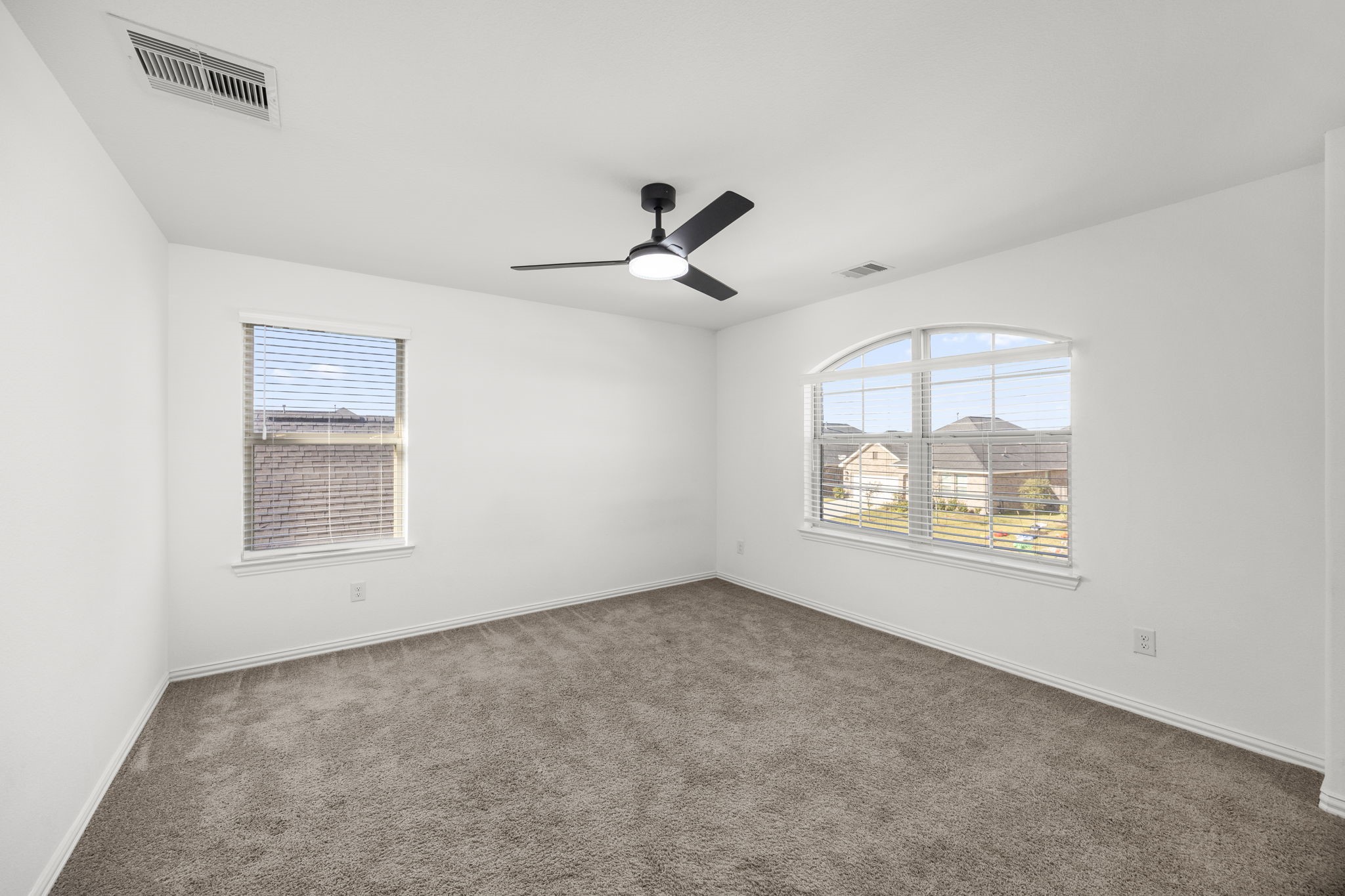 31319 Horseshoe Meadow Bend Lane Fulshear, TX 77441 - Photo 31 of 41 an empty room with windows and ceiling fan