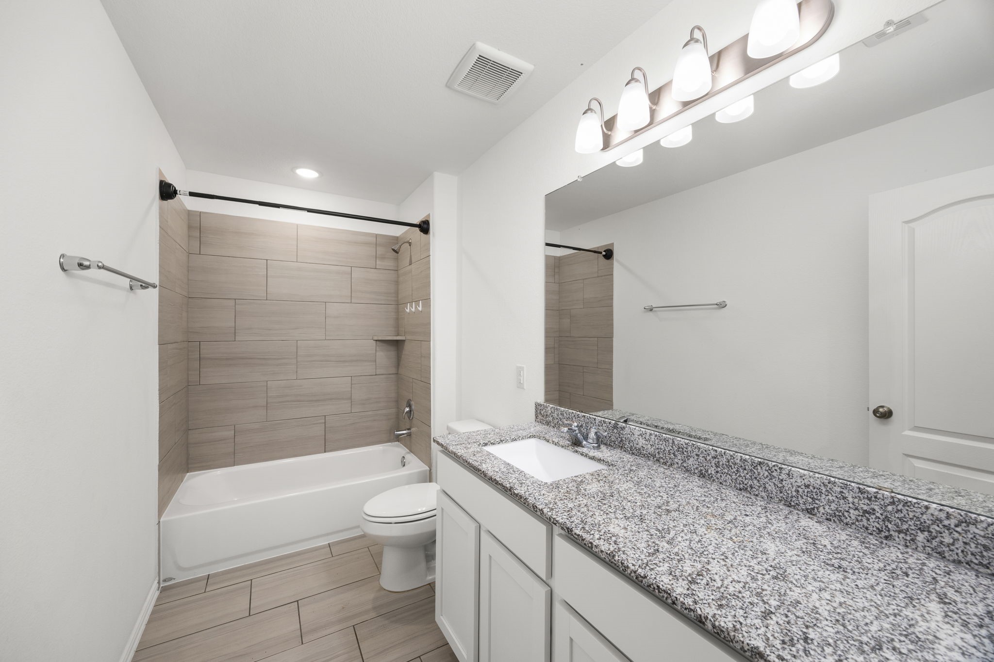 31319 Horseshoe Meadow Bend Lane Fulshear, TX 77441 - Photo 32 of 41 a bathroom with a granite countertop sink a toilet and shower