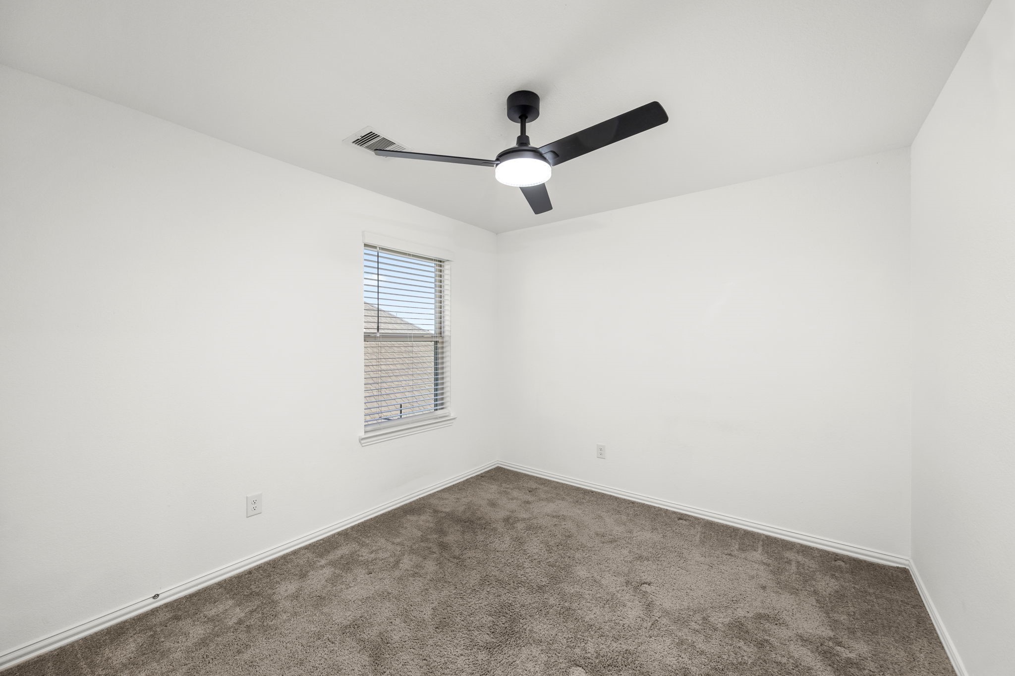 31319 Horseshoe Meadow Bend Lane Fulshear, TX 77441 - Photo 34 of 41 an empty room with a window and a fan