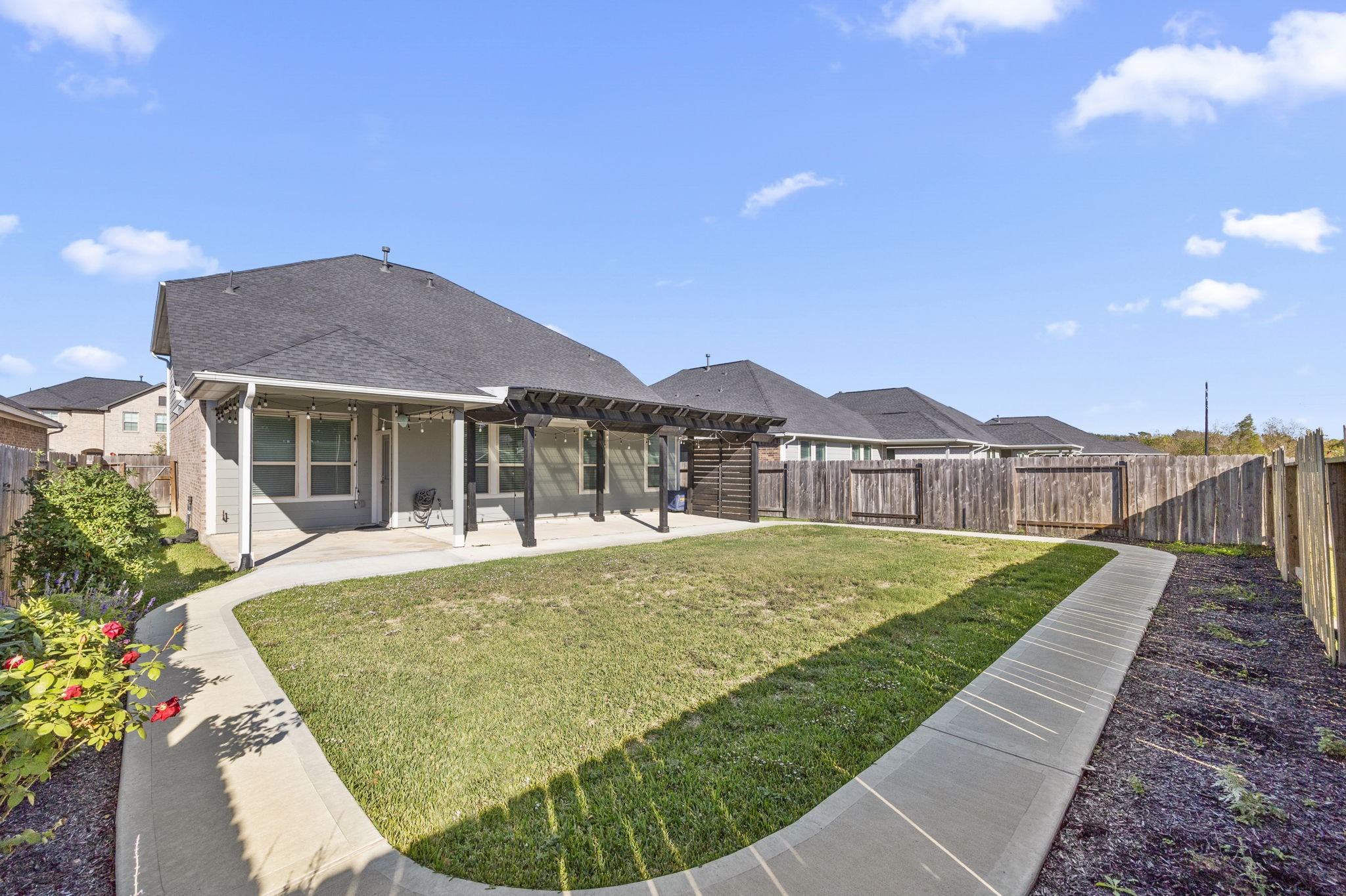 31319 Horseshoe Meadow Bend Lane Fulshear, TX 77441 - Photo 39 of 41 a view of a house with a yard and deck