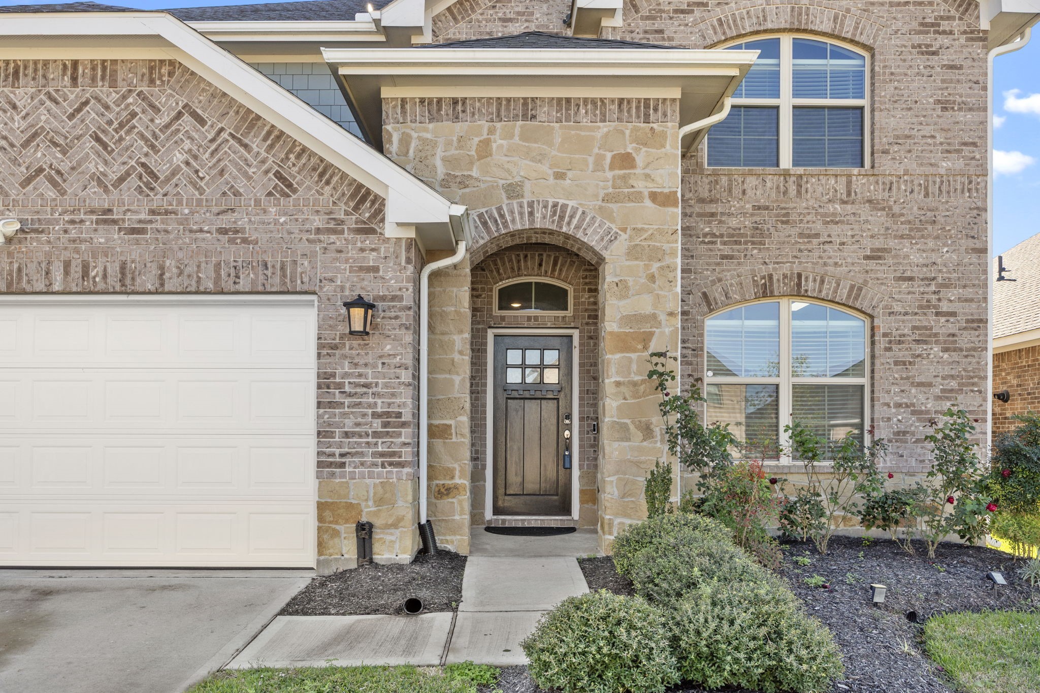 31319 Horseshoe Meadow Bend Lane Fulshear, TX 77441 - Photo 4 of 41 a front view of a house with a garden