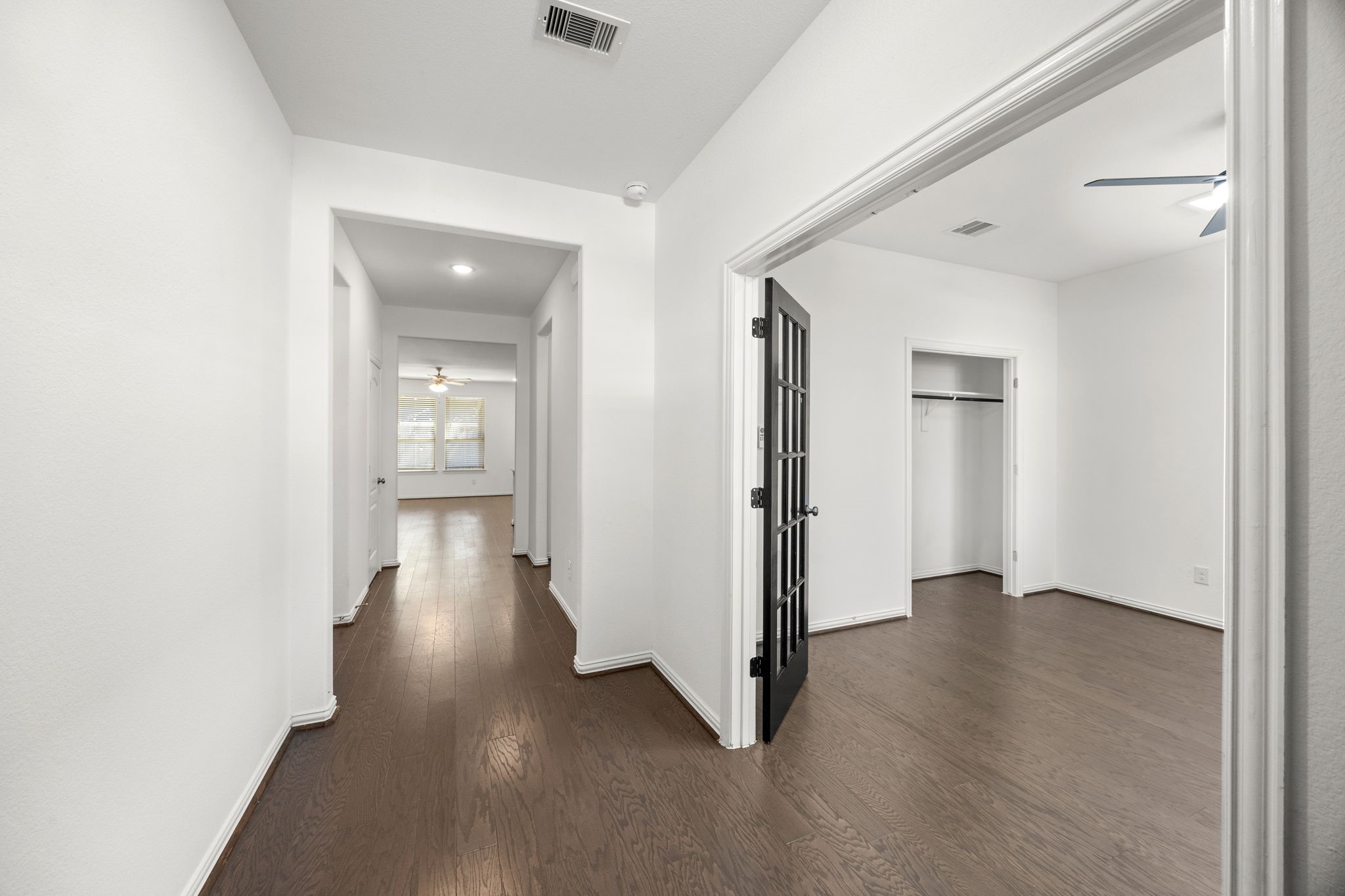 31319 Horseshoe Meadow Bend Lane Fulshear, TX 77441 - Photo 5 of 41 an empty room with wooden floor and a bathroom