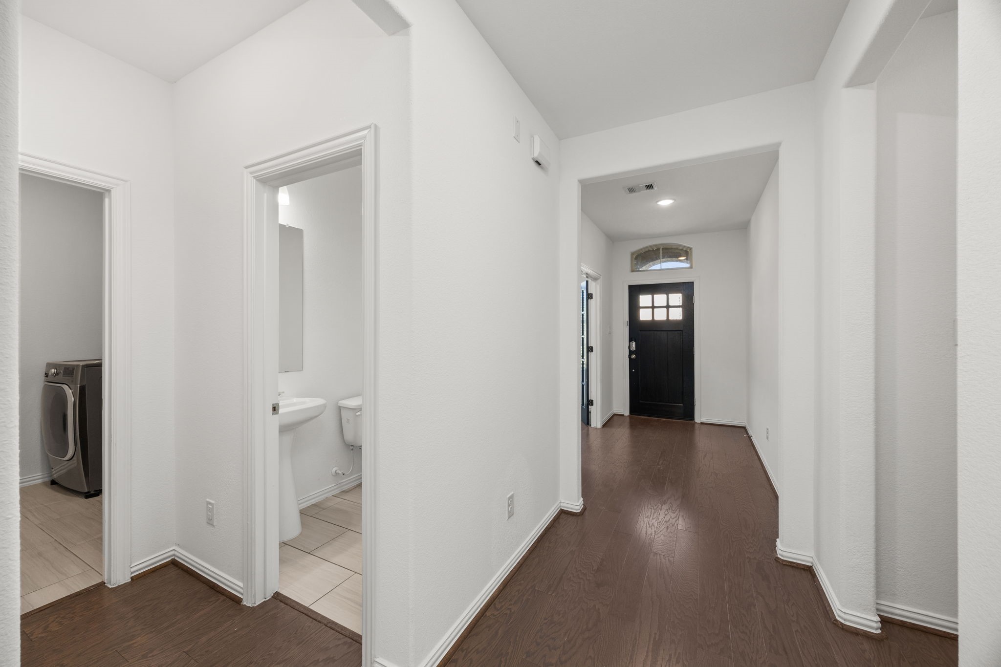 31319 Horseshoe Meadow Bend Lane Fulshear, TX 77441 - Photo 7 of 41 a view of a hallway with wooden floor and closet area