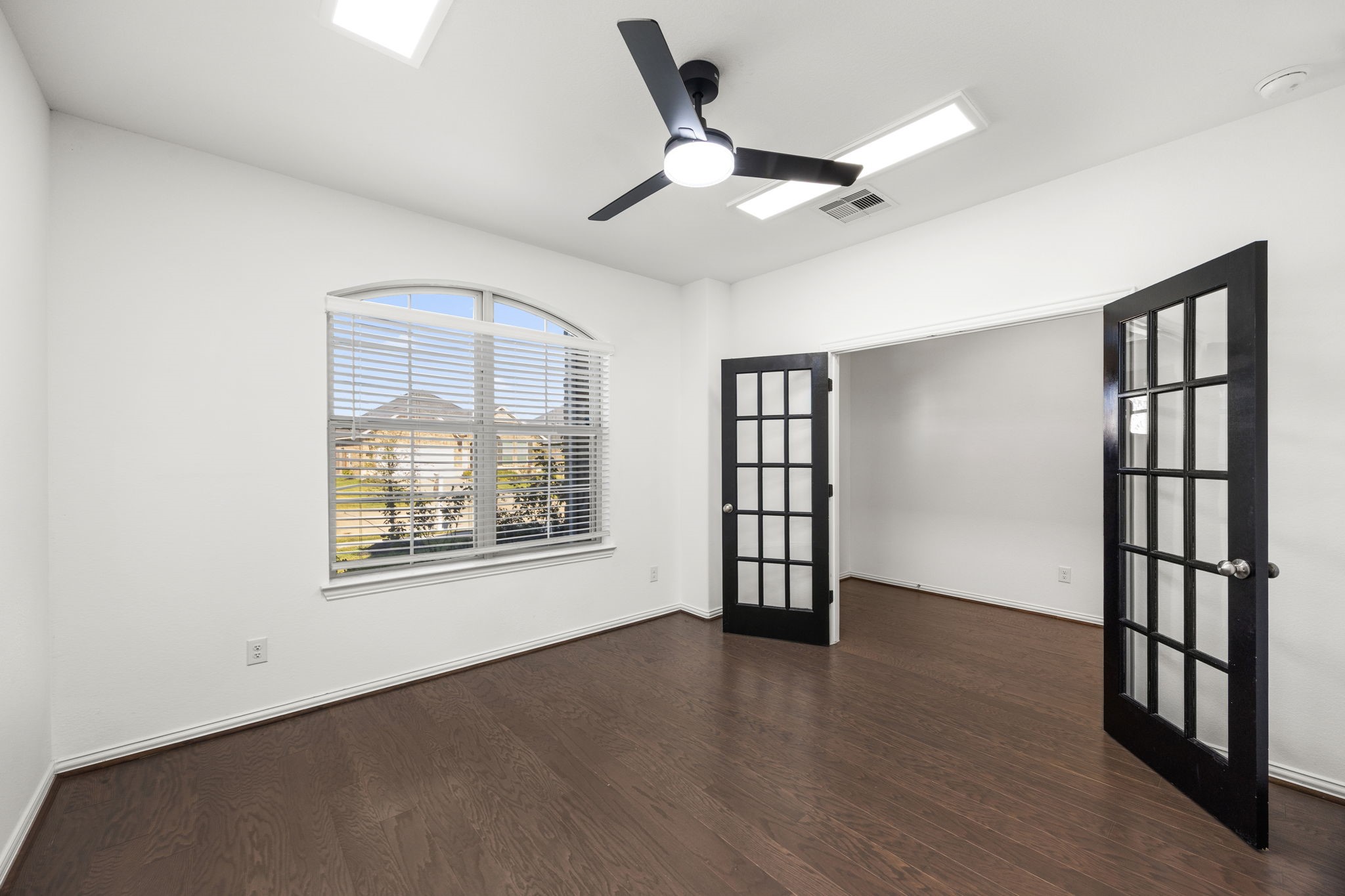 31319 Horseshoe Meadow Bend Lane Fulshear, TX 77441 - Photo 9 of 41 a view of an empty room with a window and wooden floor