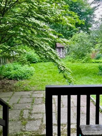 a view of backyard with outdoor seating and green space