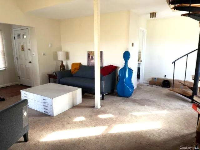 a living room with furniture and a mirror