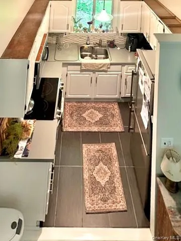 a view of a kitchen with a sink a washer and dryer