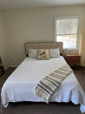 a bedroom with a bed and window