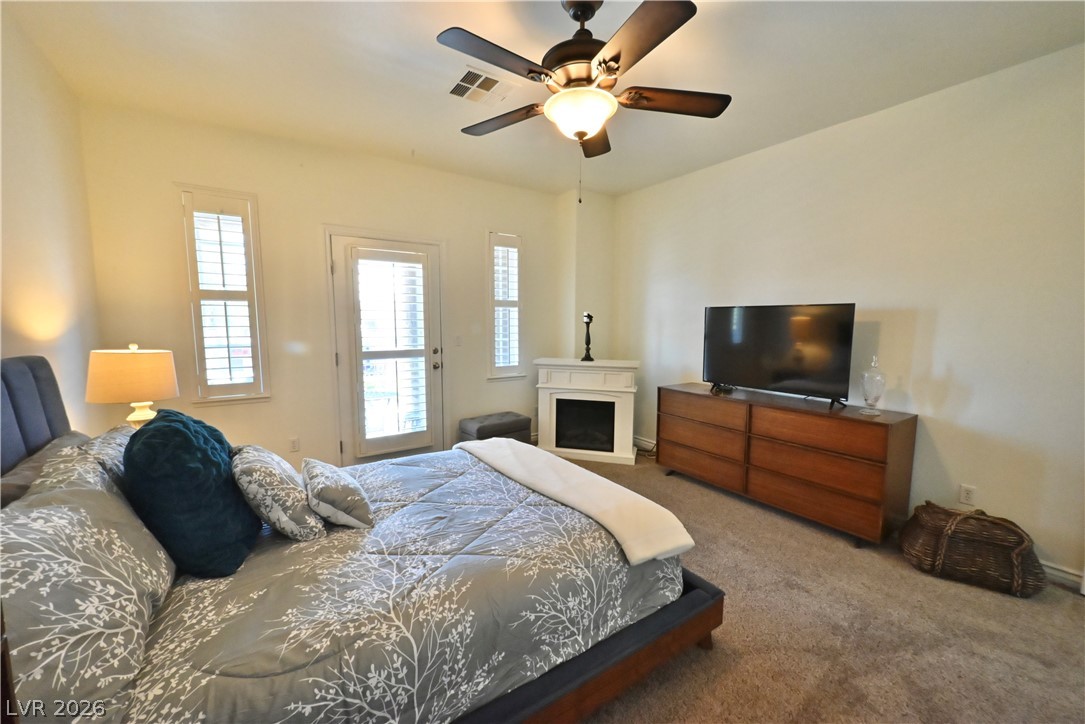 2729 Kildrummie Street Henderson, NV 89044 - Photo 24 of 42 Generous sleeping quarters featuring a corner fireplace and private outdoor access.