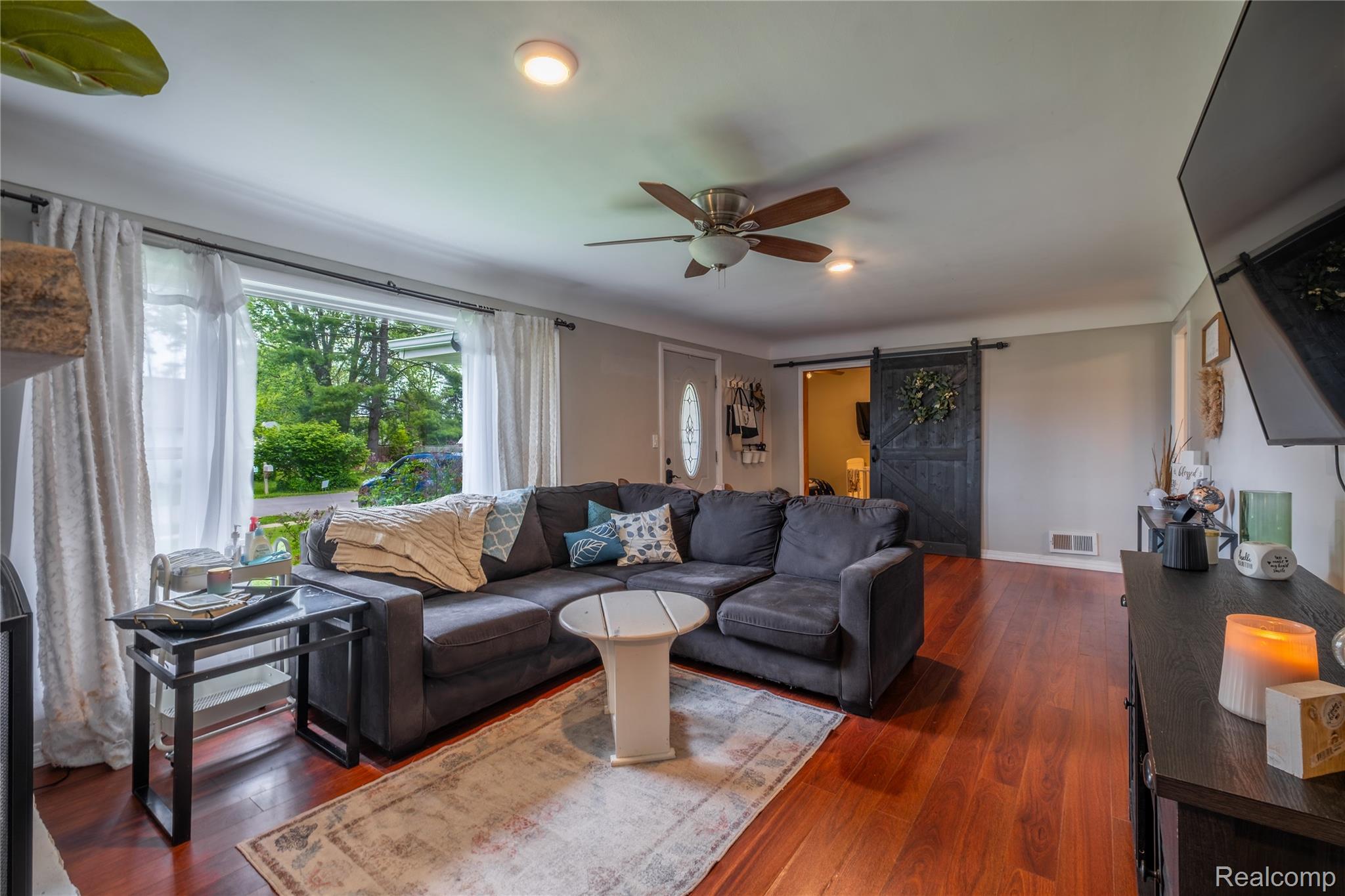 7800 Maple Street Birch Run, MI 48415 - Photo 2 of 29 Spacious living area featuring wood-finish flooring, a ceiling fan with integrated lighting, and recessed lighting