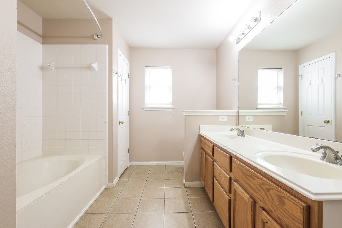 21304 Secretariat Ridge Lane Pflugerville, TX 78660 - Photo 16 of 29 a spacious bathroom with a tub sink and mirror