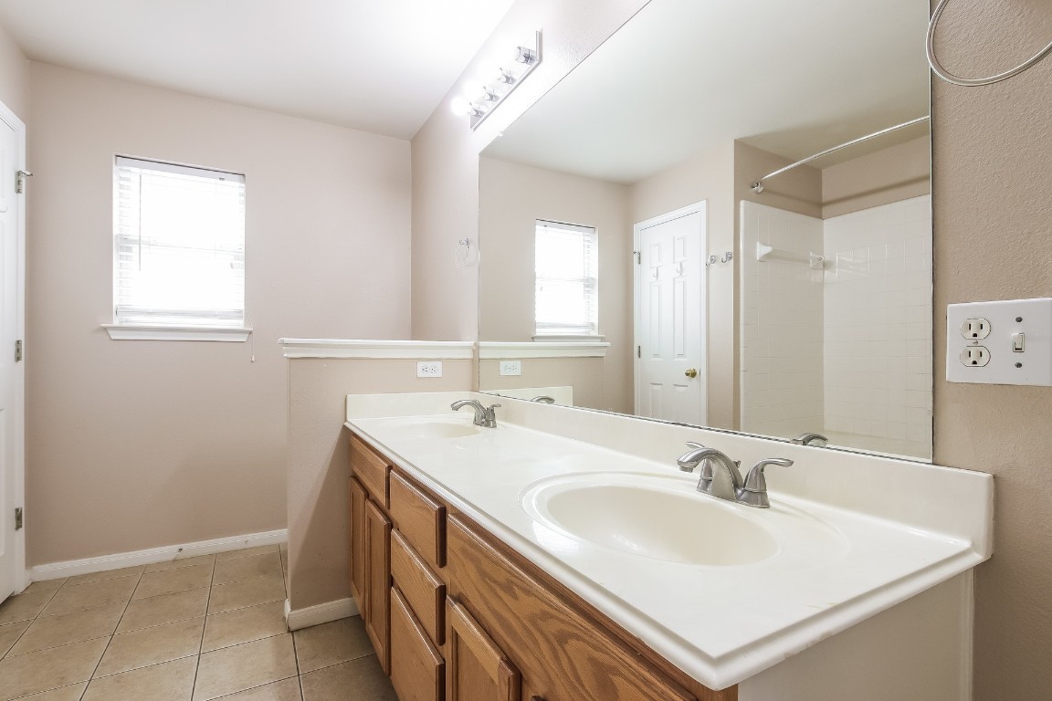 21304 Secretariat Ridge Lane Pflugerville, TX 78660 - Photo 17 of 29 a bathroom with a sink double vanity and a mirror