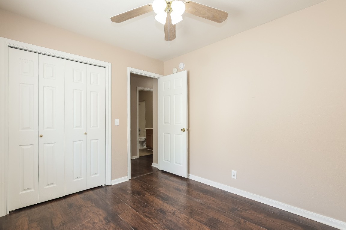 21304 Secretariat Ridge Lane Pflugerville, TX 78660 - Photo 23 of 29 an empty room with wooden floor closet and windows