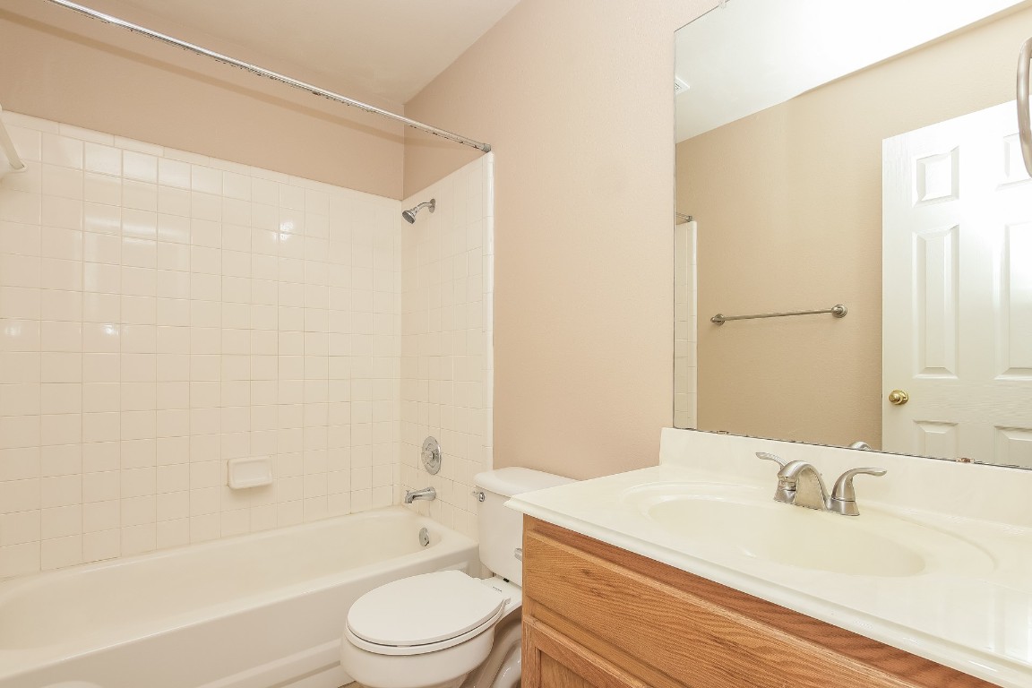 21304 Secretariat Ridge Lane Pflugerville, TX 78660 - Photo 24 of 29 a bathroom with a granite countertop sink toilet a mirror and shower