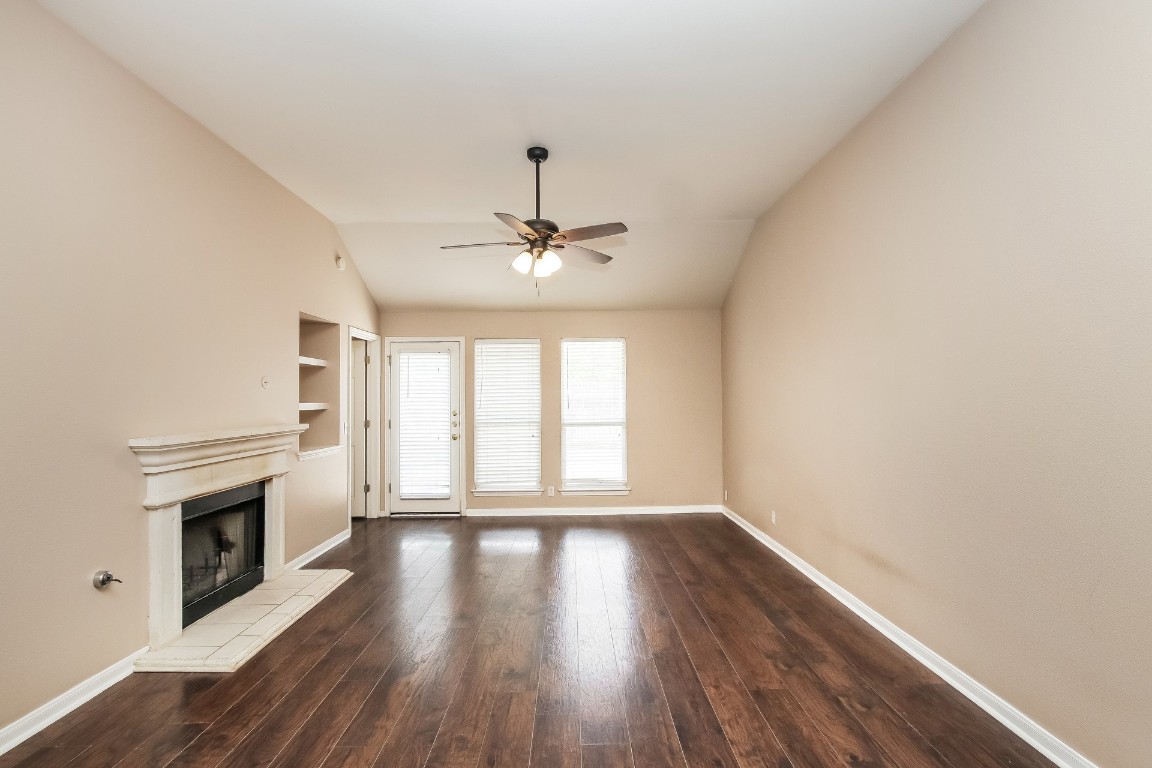 21304 Secretariat Ridge Lane Pflugerville, TX 78660 - Photo 5 of 29 a view of an empty room with wooden floor and a window