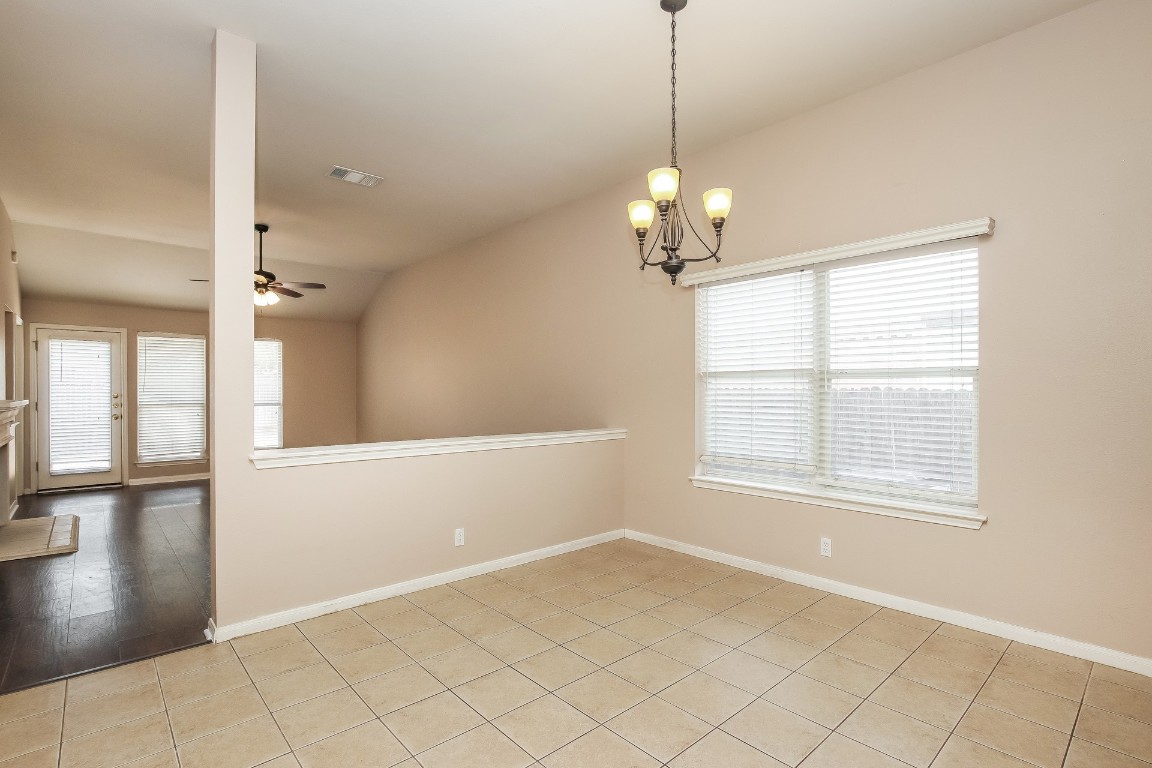 21304 Secretariat Ridge Lane Pflugerville, TX 78660 - Photo 8 of 29 a view of a livingroom with a chandelier fan and windows