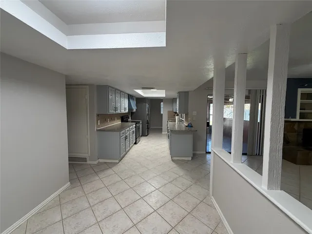 a large white kitchen with cabinets