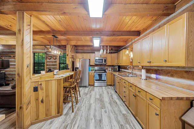 a kitchen with lots of counter top space and wooden floor