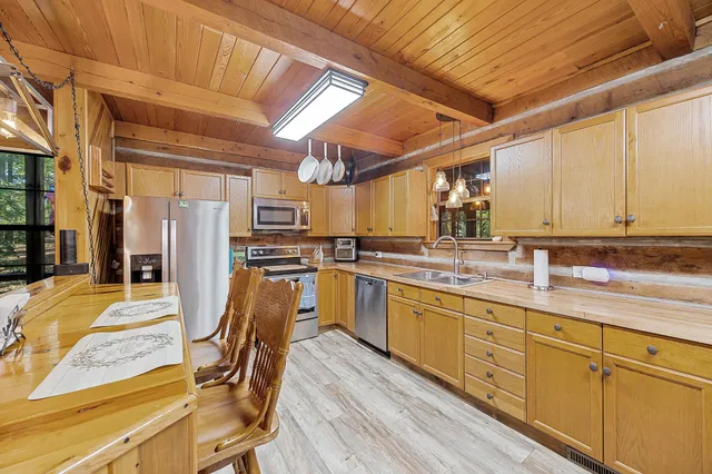 a kitchen with stainless steel appliances granite countertop a sink and cabinets