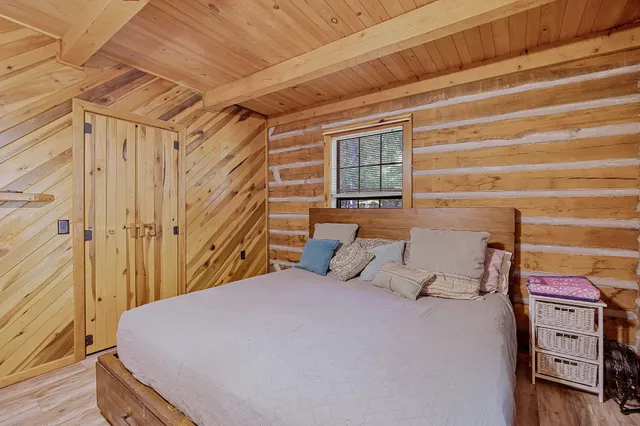 a bedroom with a bed and a mirror