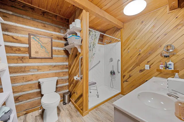 a bathroom with a toilet and a shower