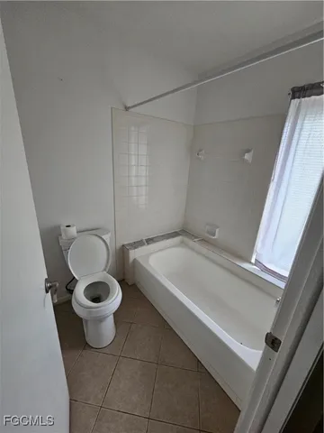 a bathroom with a tub and a shower