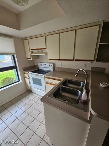 a kitchen with a sink cabinets and washing machine