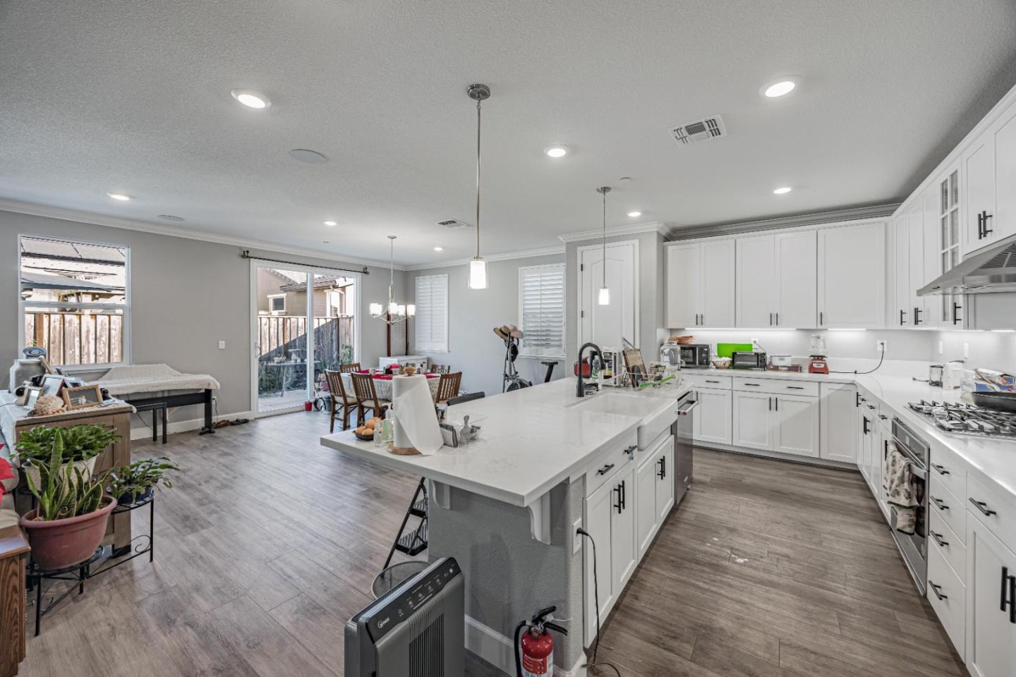 5706 Knight Road Rohnert Park, CA 94928 - Photo 12 of 36 a large white kitchen with lots of counter space a sink appliances and a living room view