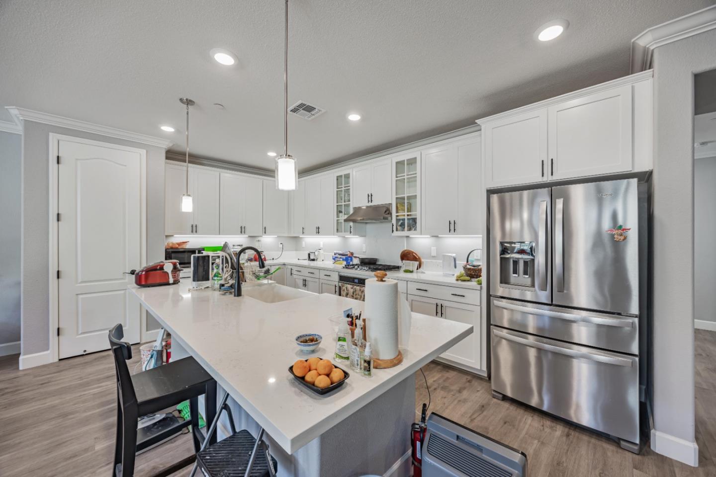 5706 Knight Road Rohnert Park, CA 94928 - Photo 9 of 36 a kitchen with kitchen island a stove a refrigerator and a dining table with wooden floor