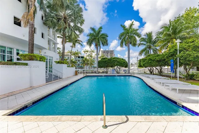a swimming pool with outdoor seating and yard