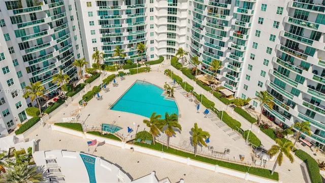 a view of a lake with couches chairs and city view