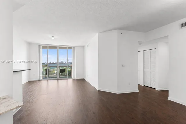 a view of kitchen with stainless steel appliances wooden floor