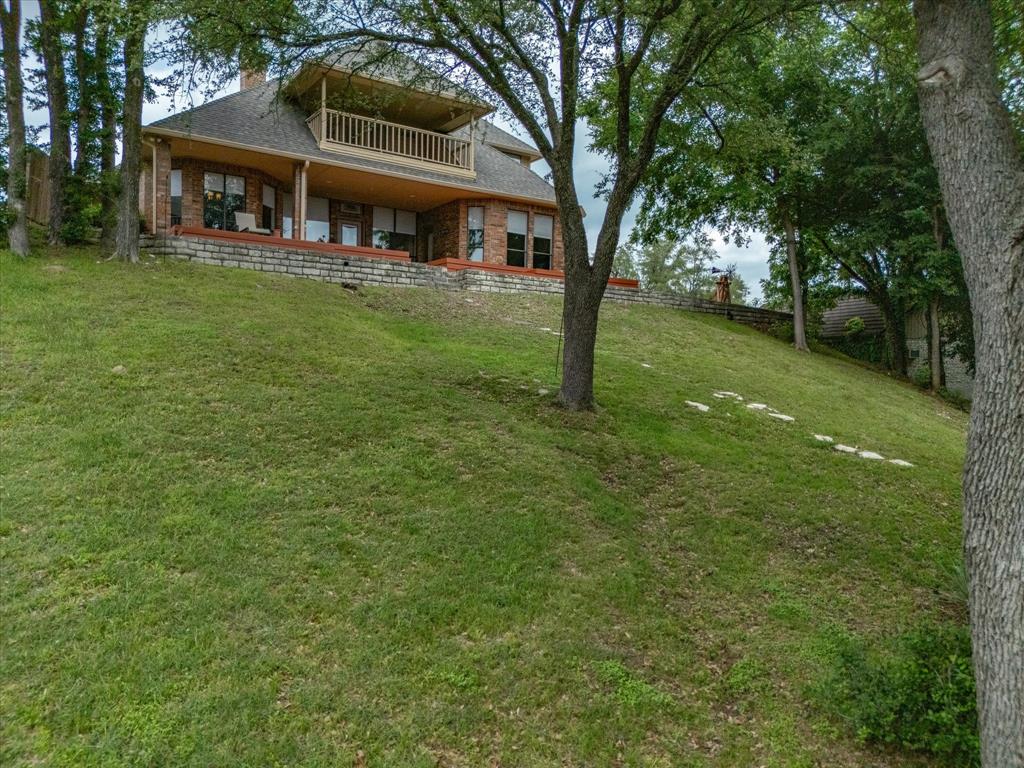 10106 Ravenswood Road Granbury, TX 76049 - Photo 32 of 39 a front view of a house with a garden