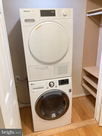 a view of a hallway with washer and dryer
