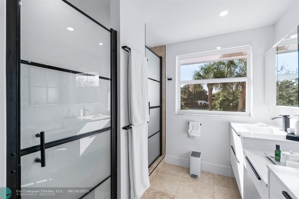 2058 Northwest 52nd Street Boca Raton, FL 33496 - Photo 18 of 35 a bathroom with a tub sink mirror and toilet