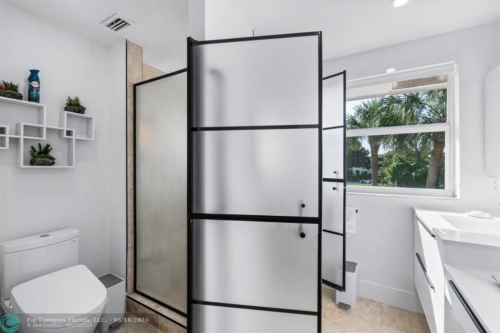 2058 Northwest 52nd Street Boca Raton, FL 33496 - Photo 19 of 35 a bathroom with a toilet shower vanity and a sink